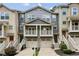 Charming townhome with two-story porch, attached garages, and well-maintained landscaping, creating inviting curb appeal at 1536 Liberty Nw Pkwy, Atlanta, GA 30318