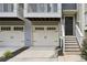 Home exterior featuring a two-car garage and a stairwell to the front door at 1536 Liberty Nw Pkwy, Atlanta, GA 30318