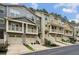 View of townhome row, featuring covered porches, garages, and landscaping, highlighting the community's appeal at 1536 Liberty Nw Pkwy, Atlanta, GA 30318
