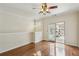 Bright living room with hardwood floors, ceiling fan and balcony, creating a welcoming and functional space at 1536 Liberty Nw Pkwy, Atlanta, GA 30318