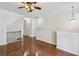 Hardwood floors throughout living room with decorative railing and ceiling fan add a classic, bright aesthetic at 1536 Liberty Nw Pkwy, Atlanta, GA 30318