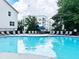 Community pool with lounge chairs and umbrellas for residents' enjoyment on a sunny day at 1536 Liberty Nw Pkwy, Atlanta, GA 30318