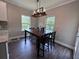 Breakfast area features a rustic chandelier and views to the wooded backyard at 17 Kola Ln, Rydal, GA 30171
