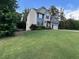 Blue sided two story house with green grass, mature trees and an attached two car garage at 17 Kola Ln, Rydal, GA 30171