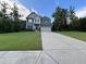 Charming two-story home with blue siding, well-manicured lawn, and attached two-car garage at 17 Kola Ln, Rydal, GA 30171