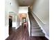 Grand foyer featuring hardwood floors, staircase, and soaring ceilings with an arched doorway to another room at 17 Kola Ln, Rydal, GA 30171