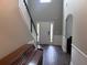 Grand foyer featuring hardwood floors, staircase, and soaring ceilings with an arched doorway to another room at 17 Kola Ln, Rydal, GA 30171
