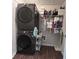 Laundry room with gray stacked washer and dryer and wire shelving with supplies at 17 Kola Ln, Rydal, GA 30171