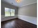 Living room with dark wood floors, light neutral colored walls, and natural light coming from the window at 17 Kola Ln, Rydal, GA 30171