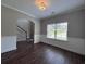 Living room with dark wood floors, light neutral colored walls, and natural light coming from the window at 17 Kola Ln, Rydal, GA 30171