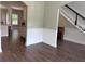 Open-concept living space with wood floors, white baseboards, and an arched doorway to another room at 17 Kola Ln, Rydal, GA 30171