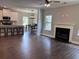 Open concept living room with wood flooring, fireplace, and breakfast bar with seating at 17 Kola Ln, Rydal, GA 30171