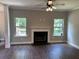 Bright living room featuring wood floors, neutral paint, a fireplace, and two windows with natural light at 17 Kola Ln, Rydal, GA 30171