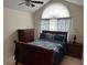 Comfortable bedroom with vaulted ceiling, dark wood furniture, and patterned curtains at 2191 Rockbridge Road # 2603, Stone Mountain, GA 30087