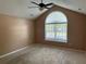 Bright bedroom featuring vaulted ceilings, neutral carpet, and a large window at 2191 Rockbridge Road # 2603, Stone Mountain, GA 30087