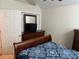 Cozy bedroom with dark wood furniture and comfortable blue patterned bedding at 2191 Rockbridge Road # 2603, Stone Mountain, GA 30087