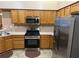 Modern kitchen boasts stainless steel appliances and wood cabinets for ample storage at 2191 Rockbridge Road # 2603, Stone Mountain, GA 30087