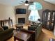 Inviting living room features a fireplace, ceiling fan, and an abundance of natural light at 2191 Rockbridge Road # 2603, Stone Mountain, GA 30087