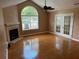 Spacious living room boasts a fireplace, large windows, and hardwood floors at 2191 Rockbridge Road # 2603, Stone Mountain, GA 30087