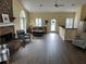 Inviting living room featuring a stone fireplace, hardwood floors, and comfortable seating at 2191 Rockbridge Road # 2603, Stone Mountain, GA 30087