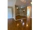 Open living room with hardwood floors, mirrored wall and neutral paint colors at 2191 Rockbridge Road # 2603, Stone Mountain, GA 30087