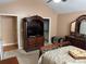 Spacious main bedroom with neutral carpet, coordinated furniture, including a TV armoire and a sleigh bed at 2191 Rockbridge Road # 2603, Stone Mountain, GA 30087