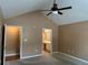 Comfortable main bedroom featuring carpet, vaulted ceilings, and access to the ensuite bathroom at 2191 Rockbridge Road # 2603, Stone Mountain, GA 30087