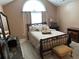 Cozy main bedroom featuring a tray ceiling, large window, neutral carpet, and a sleigh bed at 2191 Rockbridge Road # 2603, Stone Mountain, GA 30087