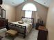 Tranquil main bedroom with a tray ceiling, neutral carpet, large window, and coordinated furnishings at 2191 Rockbridge Road # 2603, Stone Mountain, GA 30087