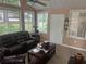 Inviting sunroom with comfortable seating, neutral carpet, large windows, and a ceiling fan at 2191 Rockbridge Road # 2603, Stone Mountain, GA 30087
