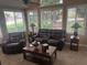 Relaxing sunroom with comfortable reclining seating, large windows, neutral carpet, and a ceiling fan at 2191 Rockbridge Road # 2603, Stone Mountain, GA 30087