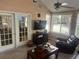 Bright sunroom featuring a ceiling fan, large windows, neutral carpet, and a set of french doors at 2191 Rockbridge Road # 2603, Stone Mountain, GA 30087