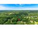 An aerial perspective of the home's location in a neighborhood surrounded by mature trees and expansive green spaces at 225 Hitchcock Dr, Villa Rica, GA 30180