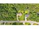 Aerial view of a charming house with a well-manicured lawn, nestled among lush green trees at 225 Hitchcock Dr, Villa Rica, GA 30180
