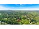 A home nestled in a dense, lush green forest under a clear blue sky, offering a serene and private setting at 225 Hitchcock Dr, Villa Rica, GA 30180