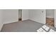 An open-concept bedroom is shown, with white walls, carpeted floors and lots of natural light at 225 Hitchcock Dr, Villa Rica, GA 30180