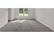 A bright bedroom offers a large window and carpeted floors at 225 Hitchcock Dr, Villa Rica, GA 30180