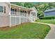 Charming home featuring a covered porch, white railings, a well-maintained lawn and a neighbor house next to it at 225 Hitchcock Dr, Villa Rica, GA 30180