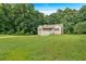 Charming home featuring a covered porch, white railings, a well-maintained lawn and long driveway at 225 Hitchcock Dr, Villa Rica, GA 30180