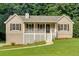Charming home featuring a covered porch, white railings, and a well-maintained lawn at 225 Hitchcock Dr, Villa Rica, GA 30180