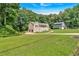 Charming home featuring a covered porch, white railings, a well-maintained lawn, driveway and a neighbor house at 225 Hitchcock Dr, Villa Rica, GA 30180