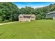 Charming home featuring a covered porch, white railings, a well-maintained lawn and driveway at 225 Hitchcock Dr, Villa Rica, GA 30180