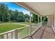 View from the porch of the home, overlooking the driveway and lawn, with trees in the background at 225 Hitchcock Dr, Villa Rica, GA 30180