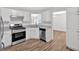 The kitchen features modern appliances, hardwood floors, white cabinets, and a gas stove at 225 Hitchcock Dr, Villa Rica, GA 30180