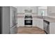 This kitchen boasts white cabinets, hardwood floors, granite countertops, and stainless steel appliances at 225 Hitchcock Dr, Villa Rica, GA 30180