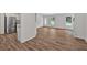 Open-concept living room with hardwood floors and seamless access to an adjoining kitchen and front entrance at 225 Hitchcock Dr, Villa Rica, GA 30180