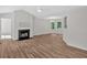 Living room with hardwood floors, a fireplace, ample natural light, and neutral paint at 225 Hitchcock Dr, Villa Rica, GA 30180