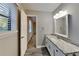 Bright bathroom featuring a granite countertop vanity, modern fixtures, and decorative mirror at 2478 Wood Meadows Sw Dr, Marietta, GA 30064