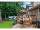 Wooden back deck with outdoor seating and an adjacent RV, surrounded by green trees at 252 Parkway Ct, Dallas, GA 30157