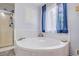 Bathroom featuring a corner bathtub with blue patterned curtains at 252 Parkway Ct, Dallas, GA 30157